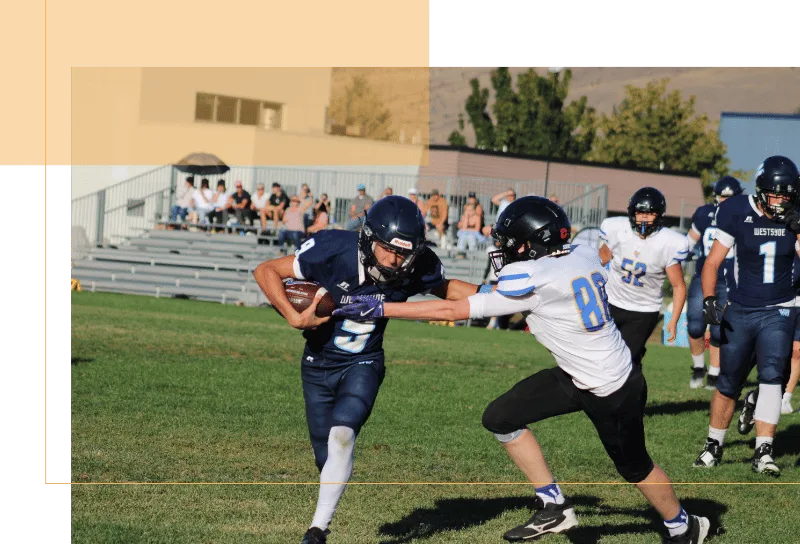 Football players running on field