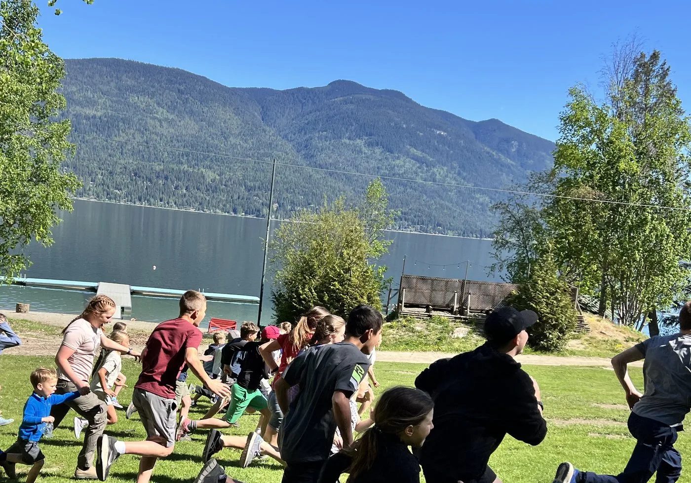 Students racing across a lakeside field