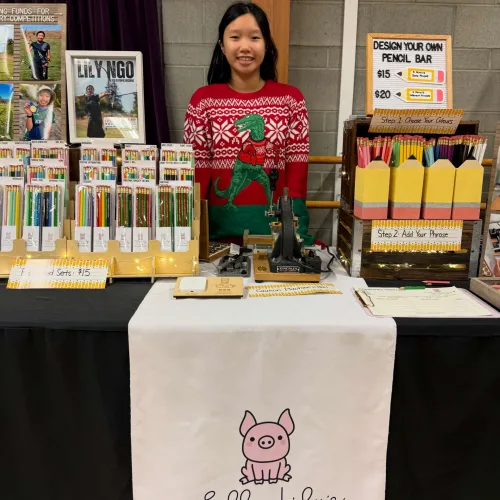 Lily standing at her vendor booth